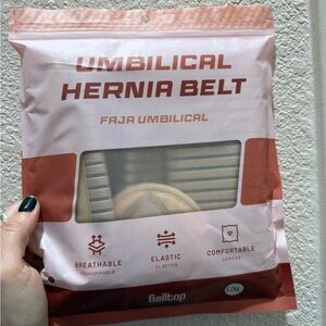 Abdominal binder with navel support